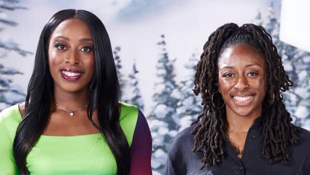 Chiney Ogwumike poses in a green dress and pink lipstick and smiles at the camera beside her sister, Nneka, who wears a black button-down.
