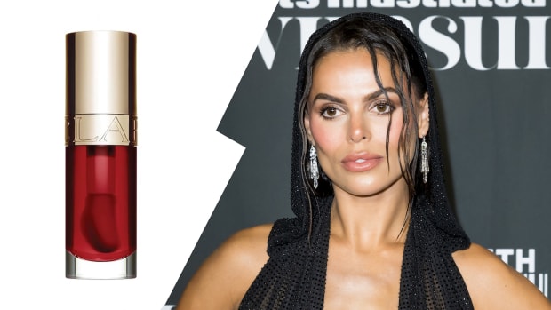 On the left, there is a bottle of red Clarins Lip Oil. On the right, Brooks Nader poses in a black halter neck dress.