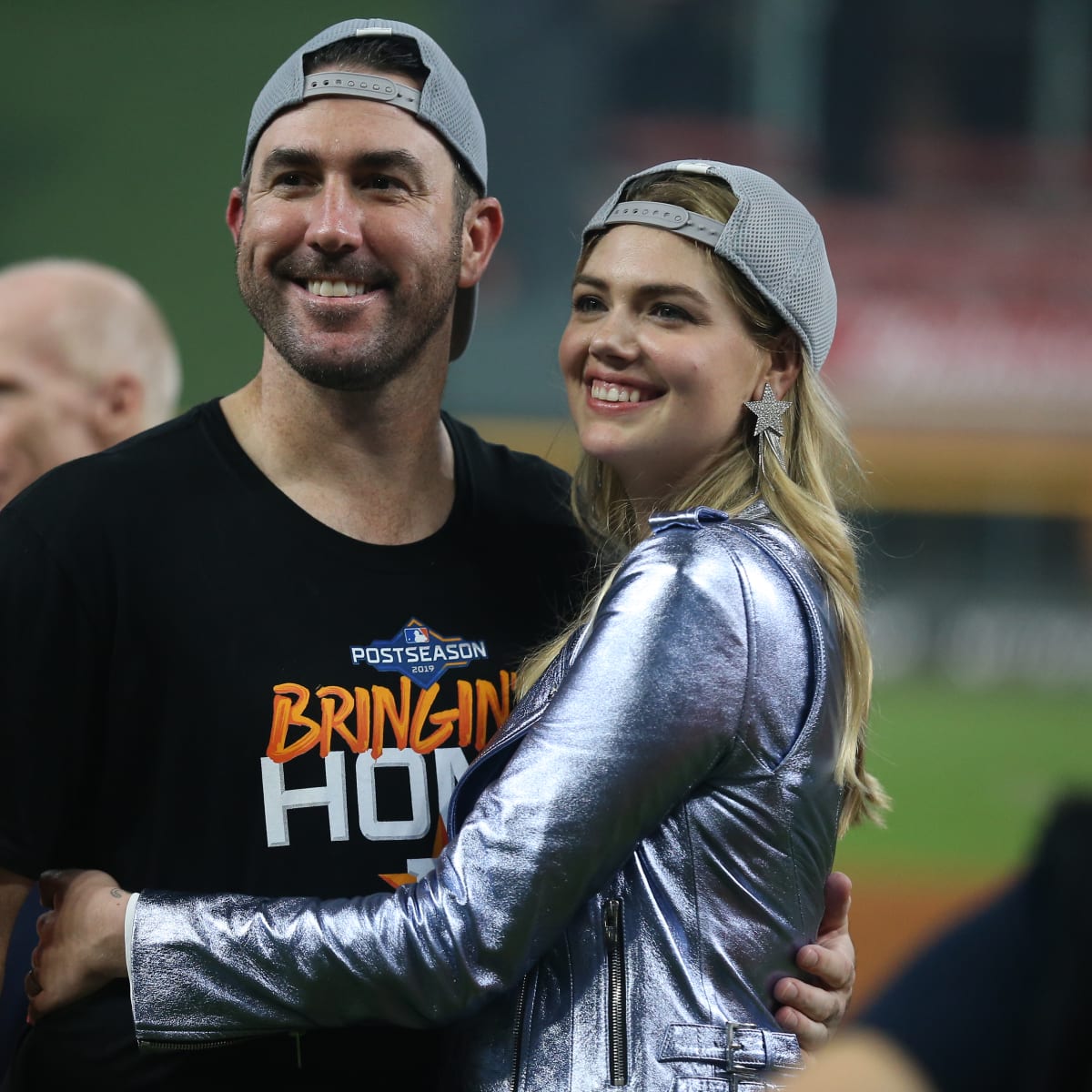 A color, born digital image of Justin Verlander #35 of the Houston Astros  smiling for a photo with his fiancé, American model and actress Kate Upton,  and the game worn jersey that