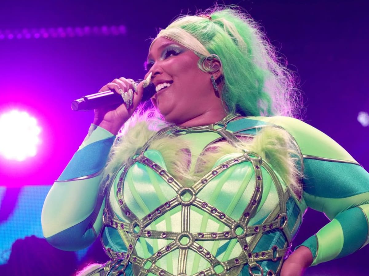 Lizzo Became the Grinch With Green Hair, a Striped Bodysuit, and a