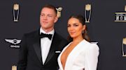 Christian McCaffrey and Olivia Culpo pose on the red carpet prior to the NFL Honors event.