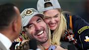 Kate Upton hugs husband Justin Verlander as the Houston pitcher does a postgame interview following the Astros’ World Series win.
