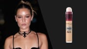 On the left, Olivia Ponton poses in a black latex bodysuit and an oversized, beaded cross necklace. On the right, there is a photo of a tan and pink bottle of Maybelline Instant Age Rewind Eraser.