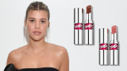 On the left, Sofia Richie wears a black strapless top and her hair in an up-do. On the right, there are two silver tubes of YSL lipstick.