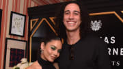 Vanessa Hudgens and Cole Tucker pose side-by-side and smile for the camera.