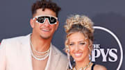 Patrick and Brittany Mahomes poses side-by-side on the ESPYS red carpet and smile for the camera.