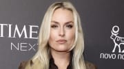 Lindsey Vonn poses in a brown suede jacket and smiles softly for the camera.