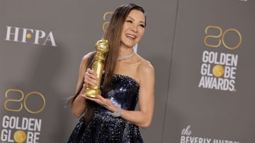 Michelle Yeoh poses with Best Actress in a Motion Picture – Musical or Comedy Golden Globes award.