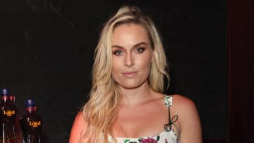 Lindsey Vonn poses in a floral-printed corset top and wears her blond hair in a slight wave.
