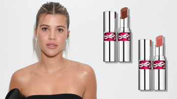 On the left, Sofia Richie wears a black strapless top and her hair in an up-do. On the right, there are two silver tubes of YSL lipstick.