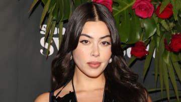 Lauren Chan poses in a black dress and wears her hair in a soft wave.