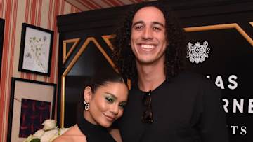 Vanessa Hudgens and Cole Tucker pose side-by-side and smile for the camera.