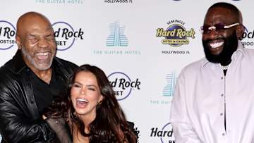 Mike Tyson, Brooks Nader and Rick Rose pose together on the red carpet and smile widely for the camera.