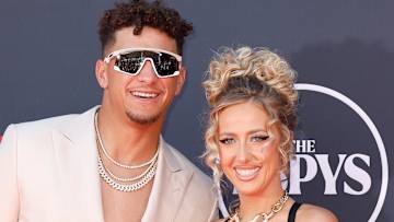 Patrick and Brittany Mahomes poses side-by-side on the ESPYS red carpet and smile for the camera.