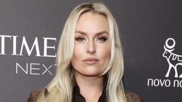 Lindsey Vonn poses in a brown suede jacket and smiles softly for the camera.