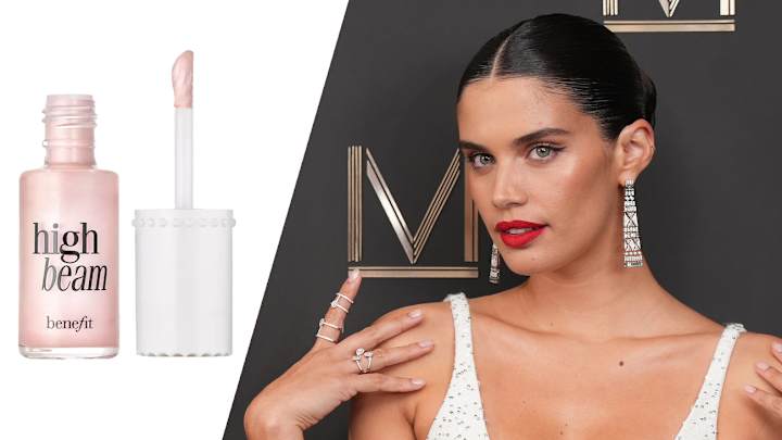 On the left, there is a bottle of Benefit Cosmetics High Beam Highlighter. On the right, Sara Sampaio poses on a red carpet in a white sparkly dress and red lipstick.