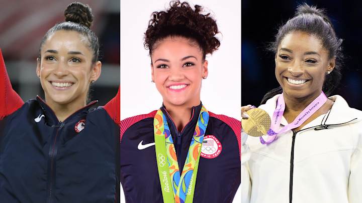 Aly Raisman, Laurie Hernandez and Simone Biles pose in their Team USA gymnastics gear and smile for the camera.