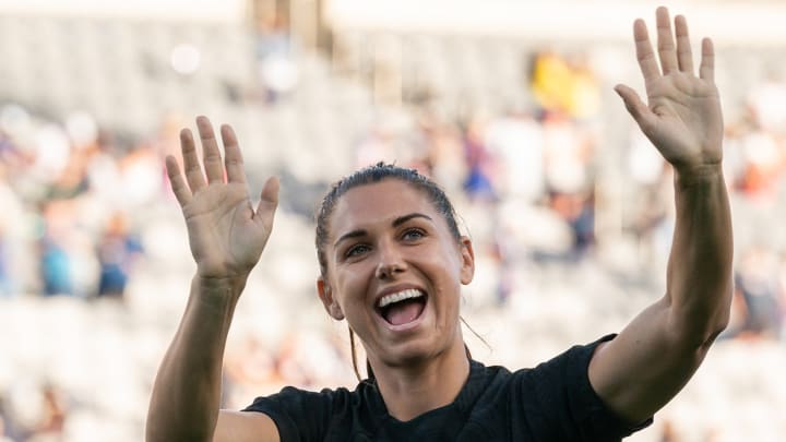 Alex Morgan waves to the crowd ahead of a USWNT match.