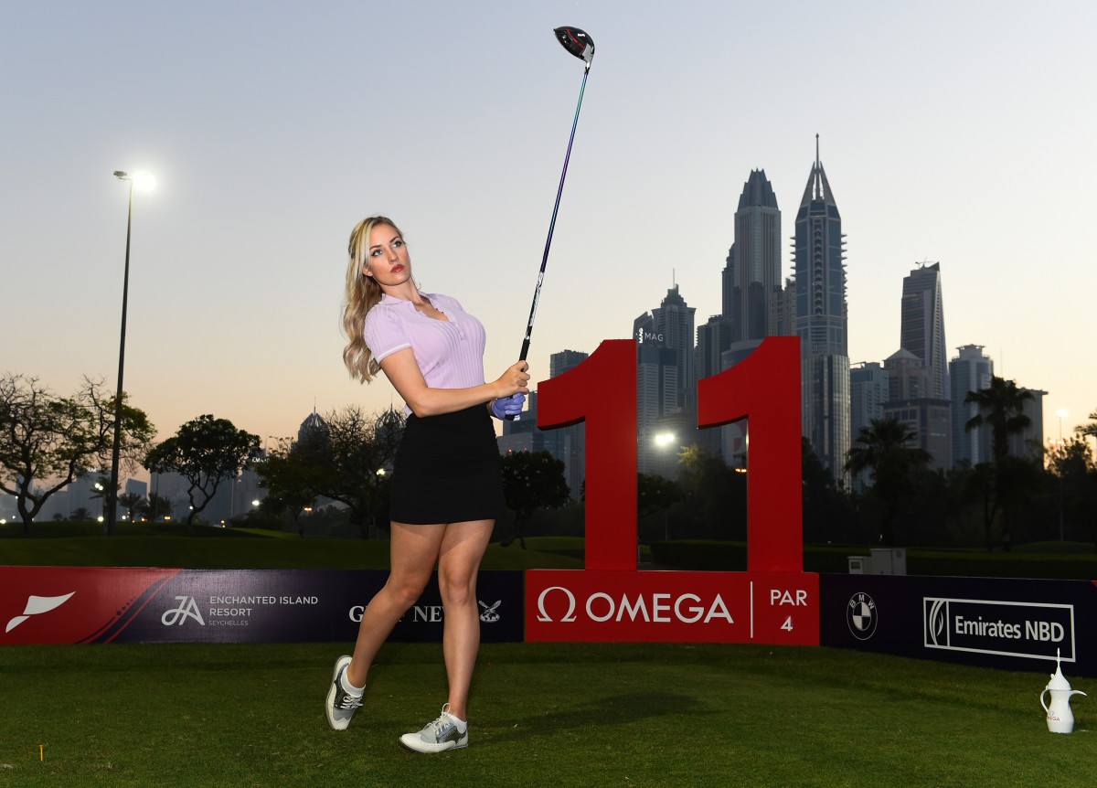 Paige Spiranac of United States poses for photographs on Day One of the Omega Dubai Moonlight Classic at Emirates Golf Club.
