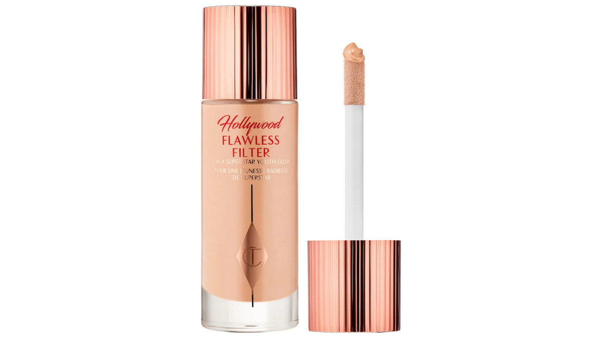 A clear bottle of tan-tinted Charlotte Tilbury Hollywood Flawless Filter with a gold top.