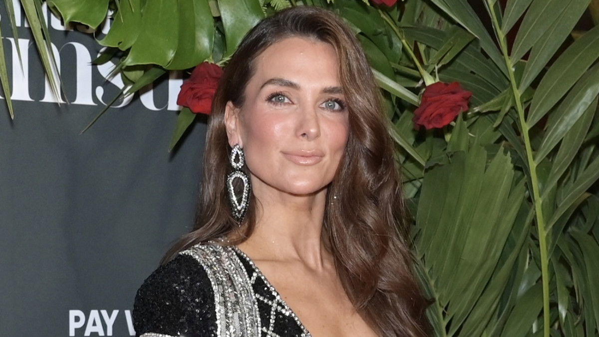 Melissa Wood-Tepperberg poses in a black and silver sequined dress and smiles at the camera.